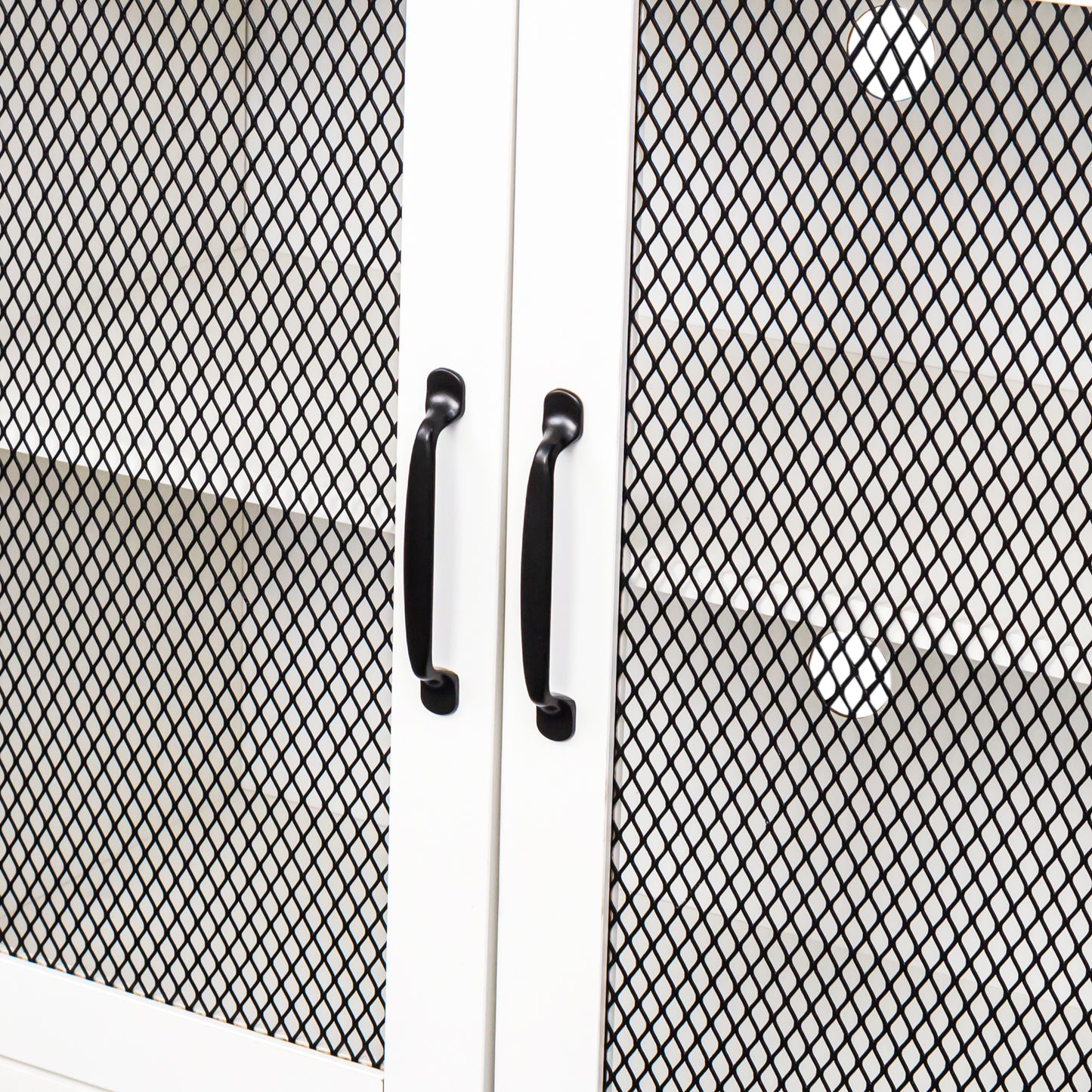 White cabinet doors with black mesh panels and matte black handles