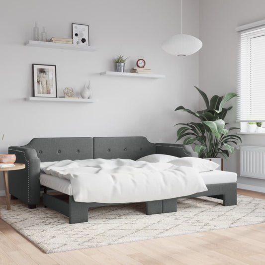 Gray fabric sofa bed with white bedding unfolded