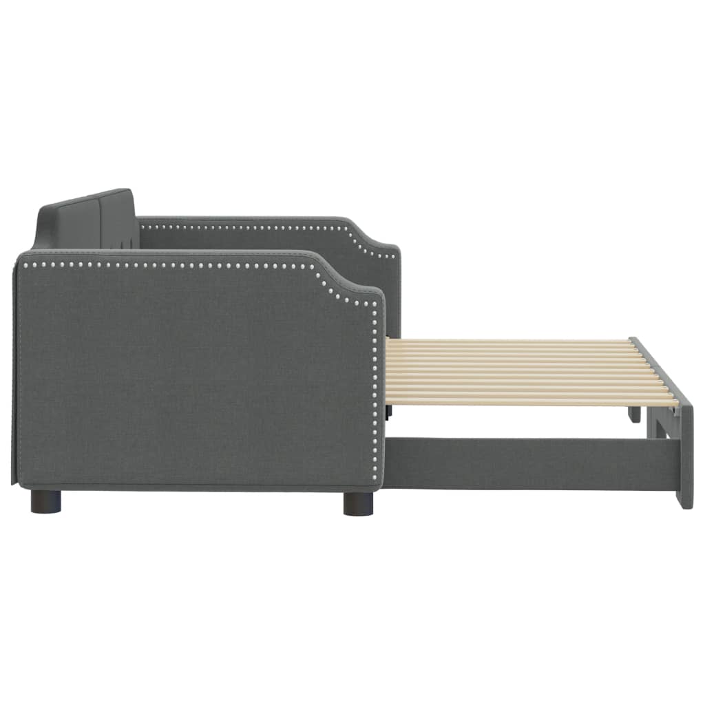 Grey upholstered daybed with button tufting and nailhead trim