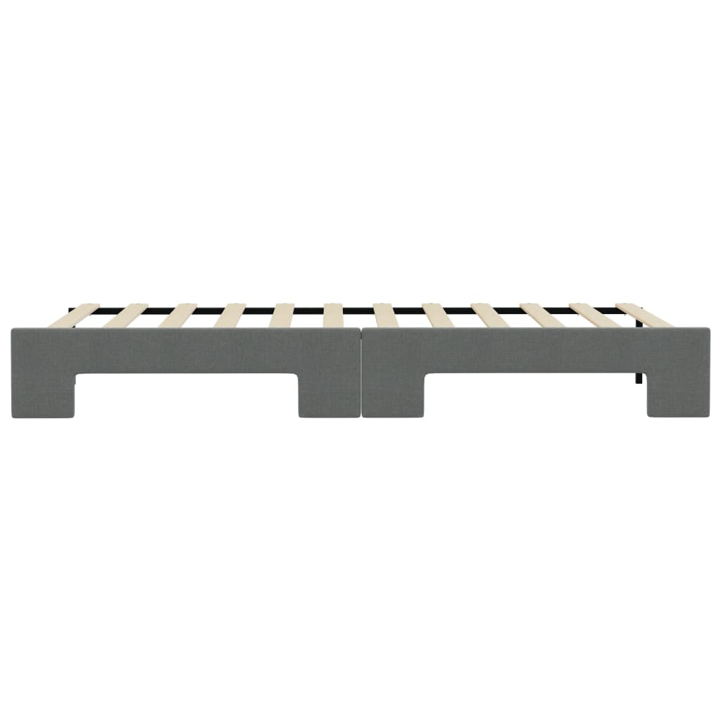 Two gray upholstered twin bed frames with wooden slats