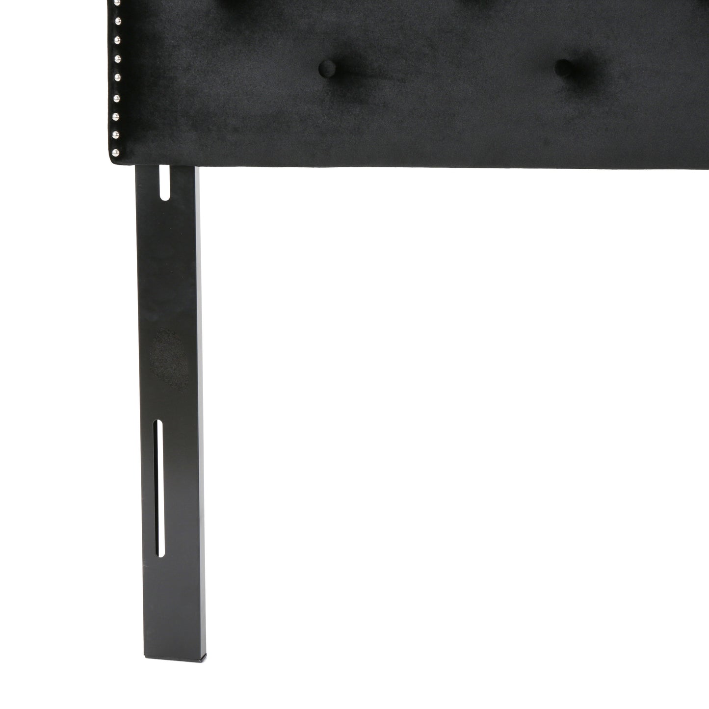 Black velvet headboard with silver nailhead trim and tufted buttons