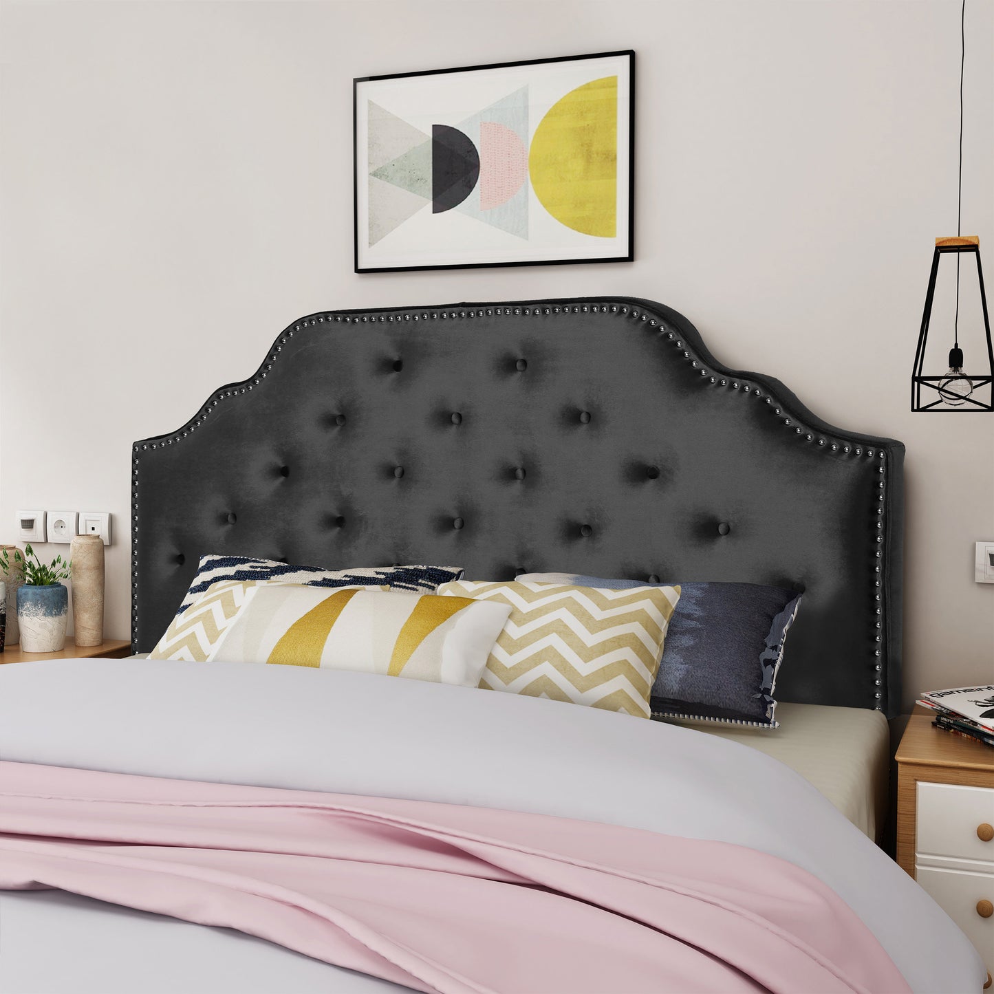 Dark gray velvet headboard with silver nailhead trim and button tufting for a stylish bedroom centerpiece