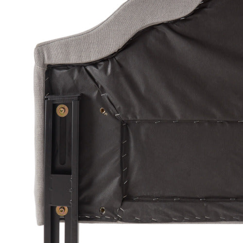 Upholstered headboard back detail showing grey fabric and metal support