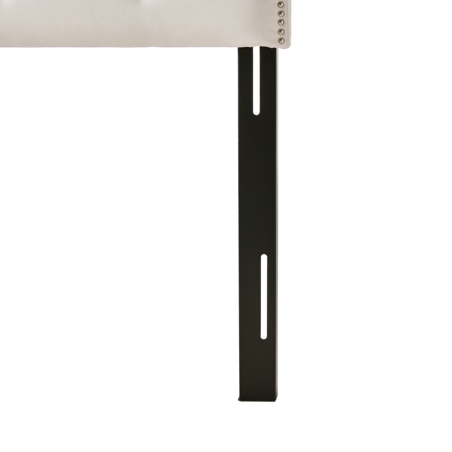 Tufted beige headboard with silver nailhead trim and black metal bed frame legs
