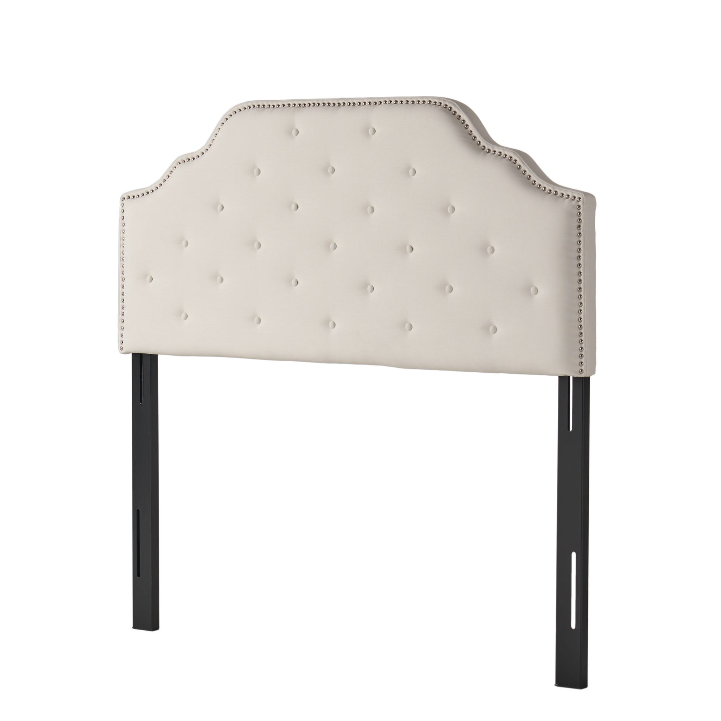 Cream upholstered headboard with diamond tufting and nailhead trim