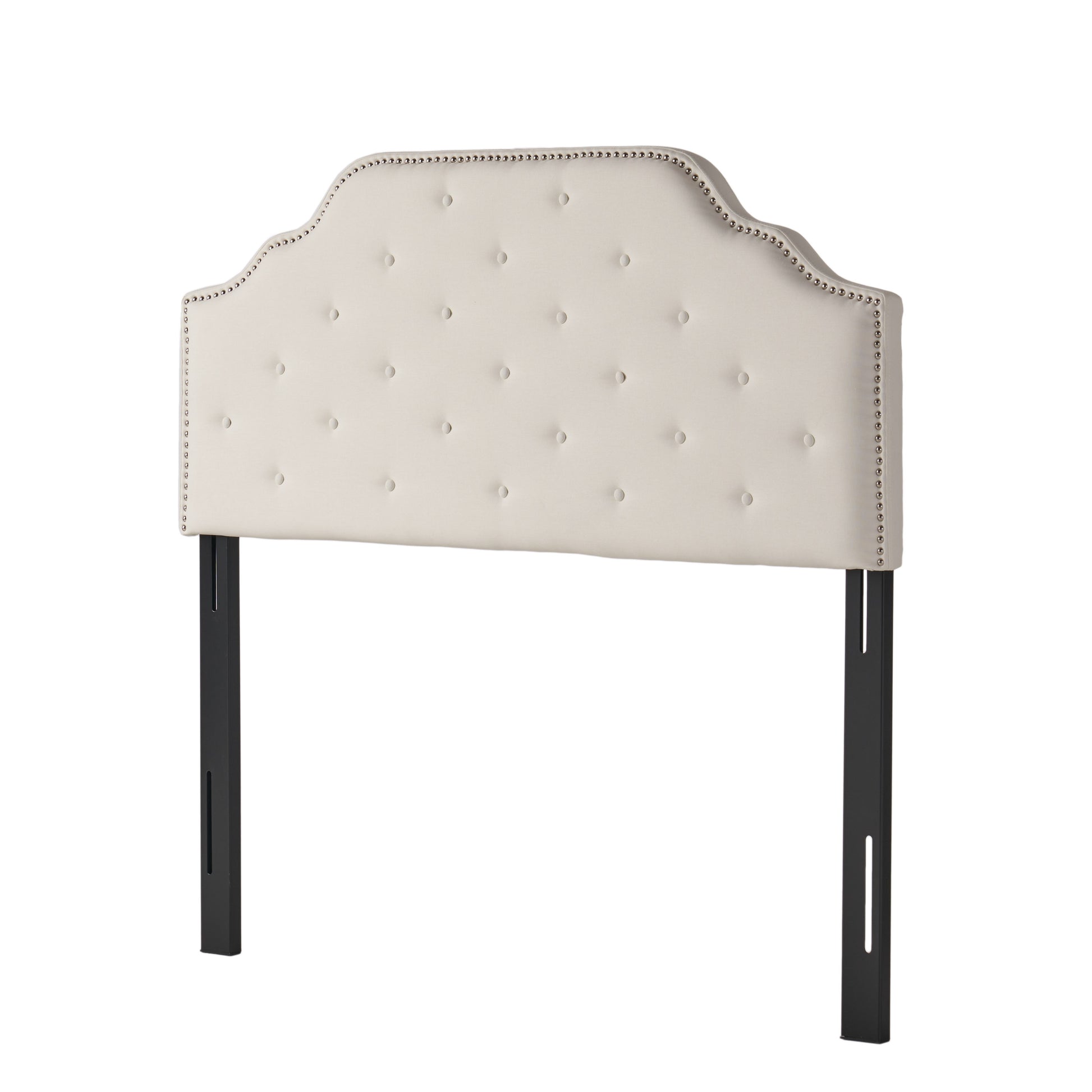 Cream upholstered headboard with diamond tufting and nailhead trim