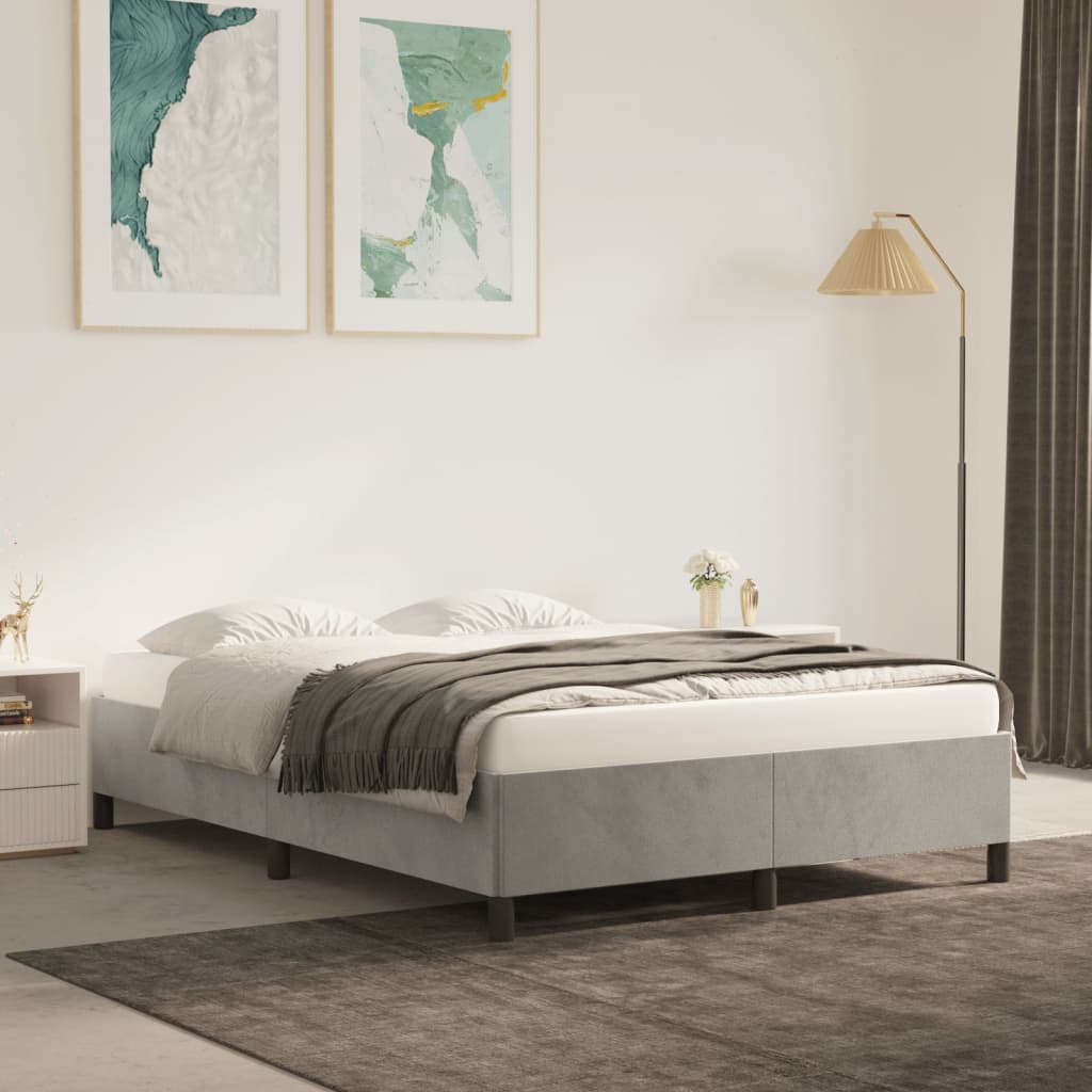 Light blue upholstered platform bed frame with metal legs set up in a modern bedroom