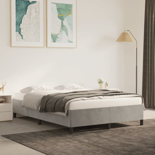 Light blue upholstered platform bed frame with metal legs set up in a modern bedroom