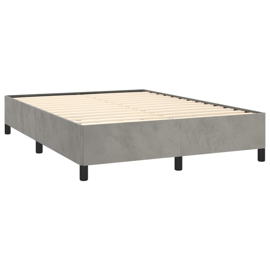 Minimalist upholstered bed frame in light blue with dark wood legs featuring a clean design for modern bedrooms
