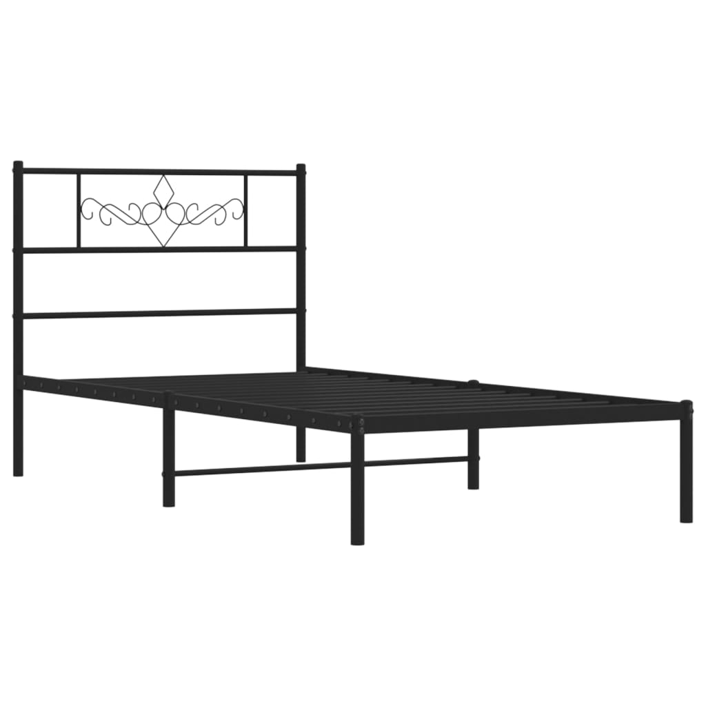 Black metal bed frame with ornate headboard and white mattress