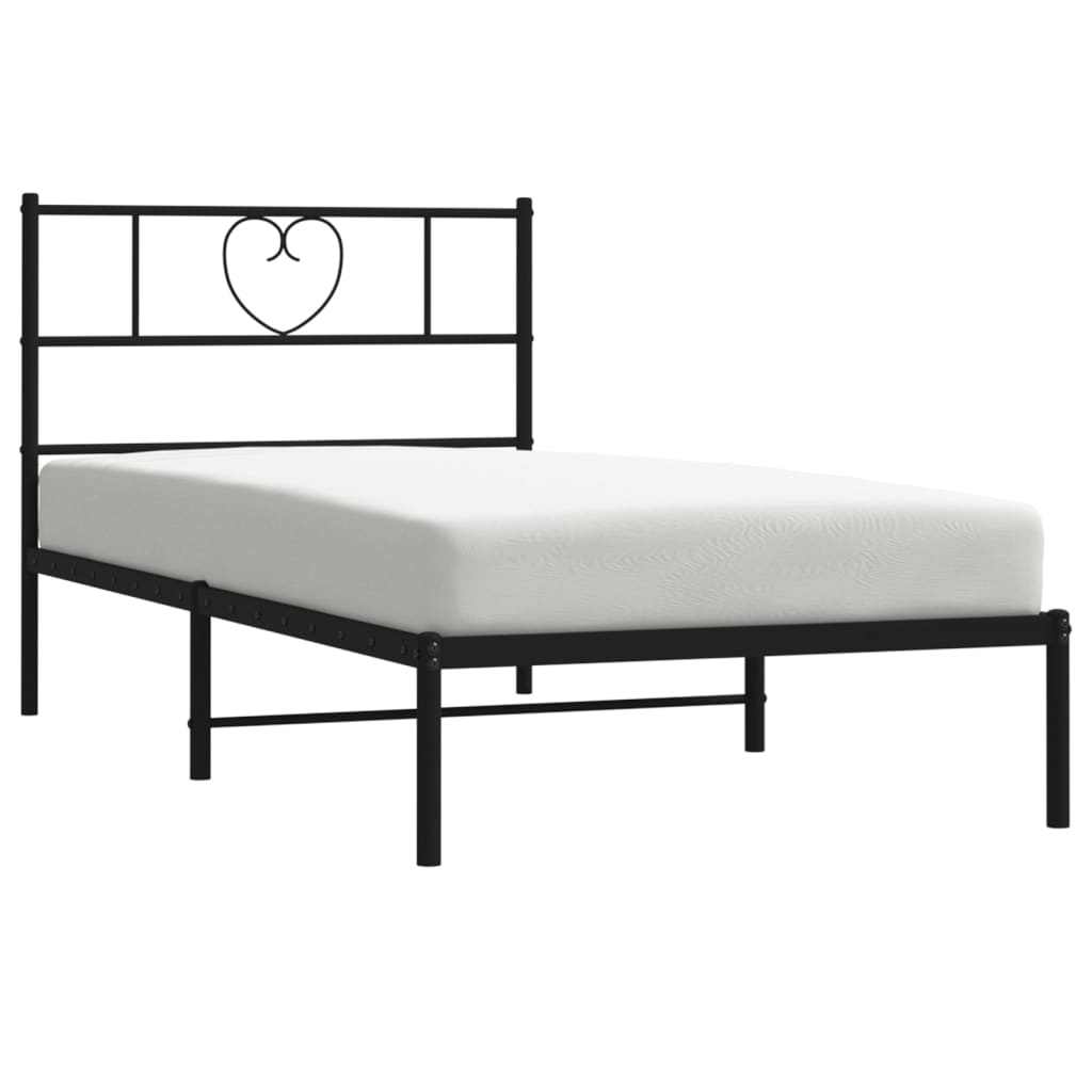 Black metal twin bed frame with heartshaped headboard and white mattress