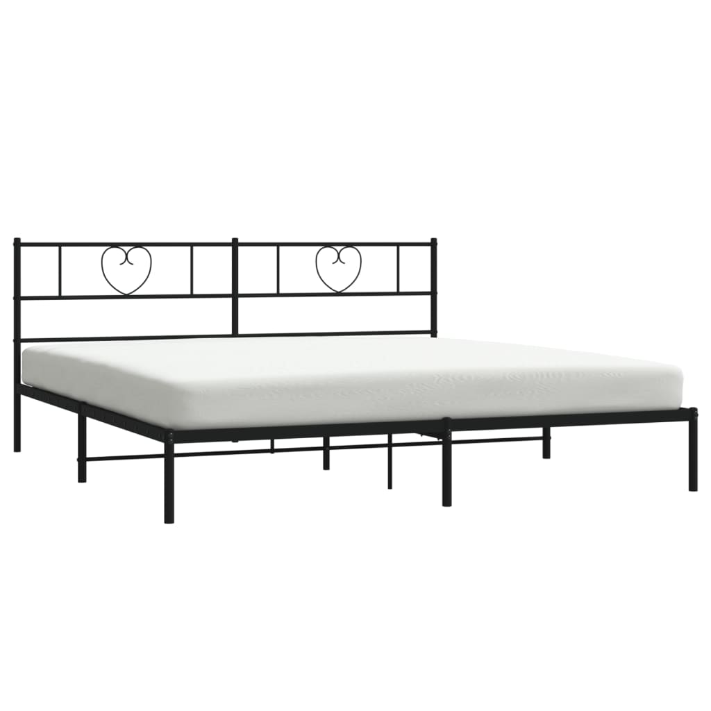Black metal bed frame with heartshaped headboard and white mattress