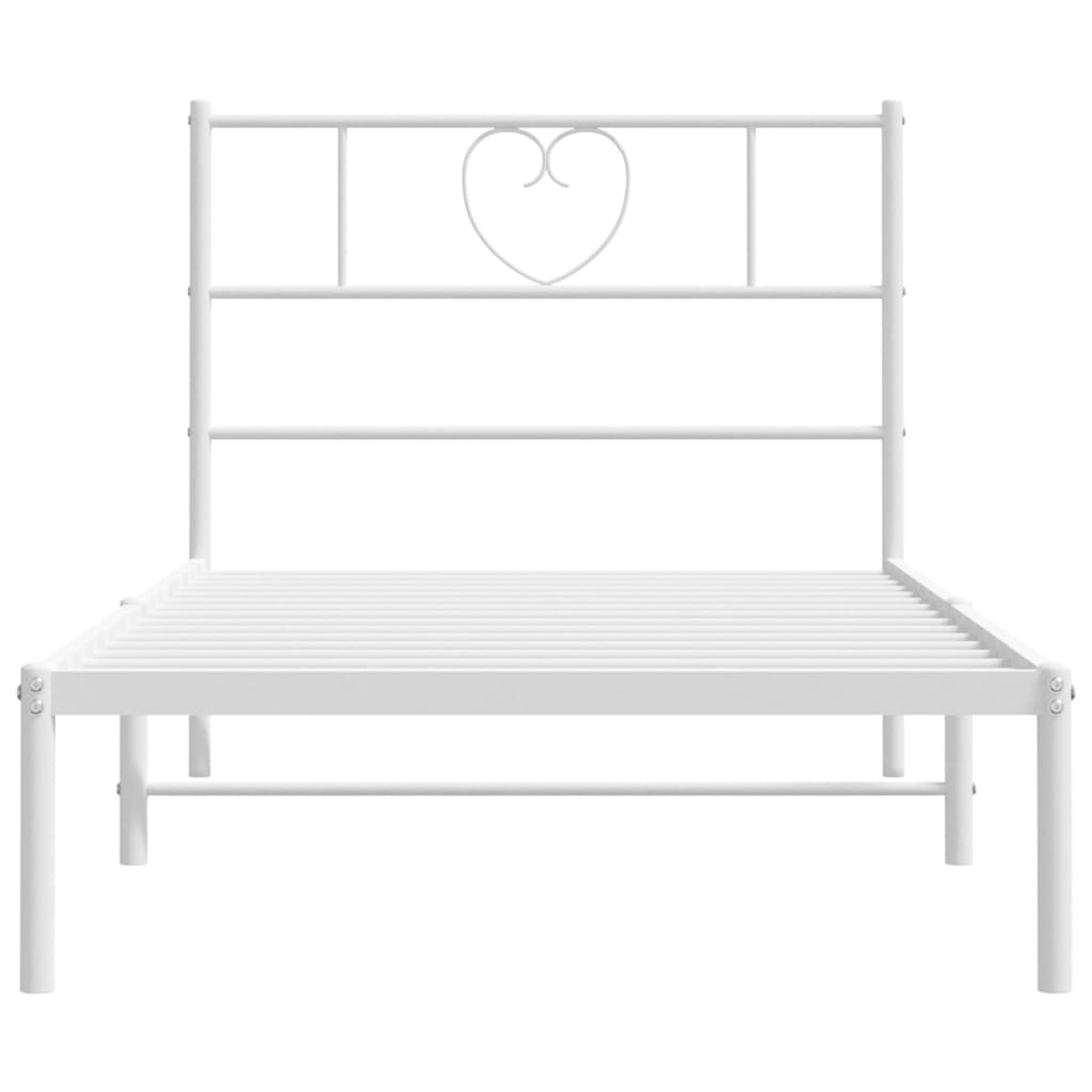 White metal bed frame with heart headboard detail and mattress