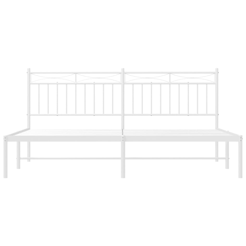 White metal bed frame with ornate headboard and mattress