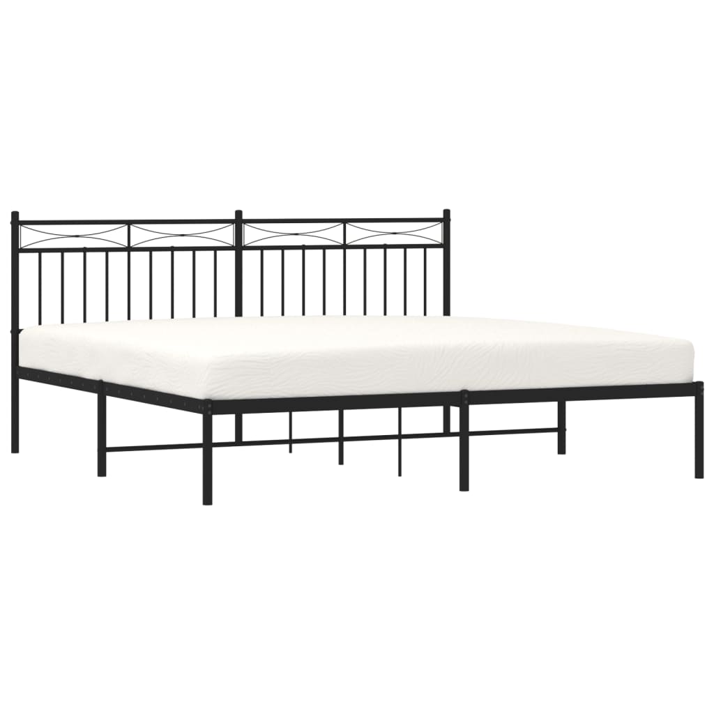 Black metal platform bed frame with a white mattress and ornate headboard