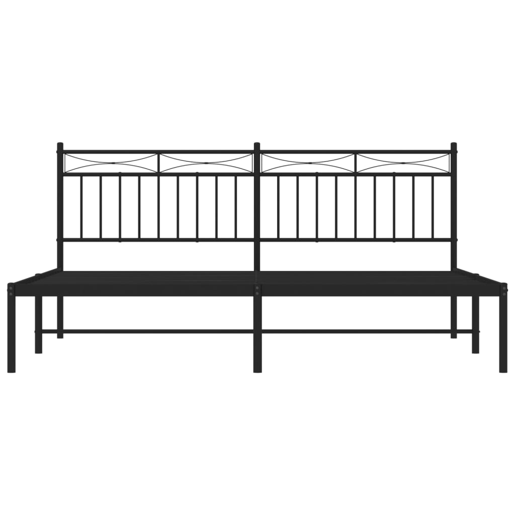 Black metal bed frame with ornate headboard and white mattress