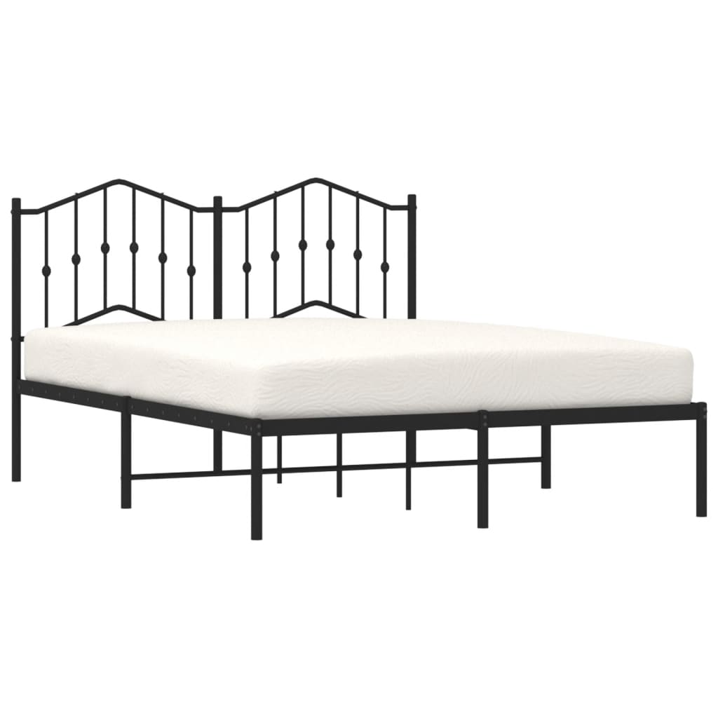 Black metal bed frame with ornate headboard and white mattress