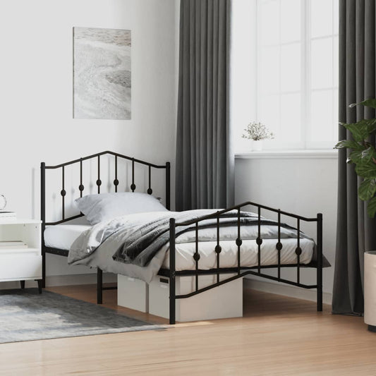 Black metal twin bed frame with decorative finials and a curved headboard