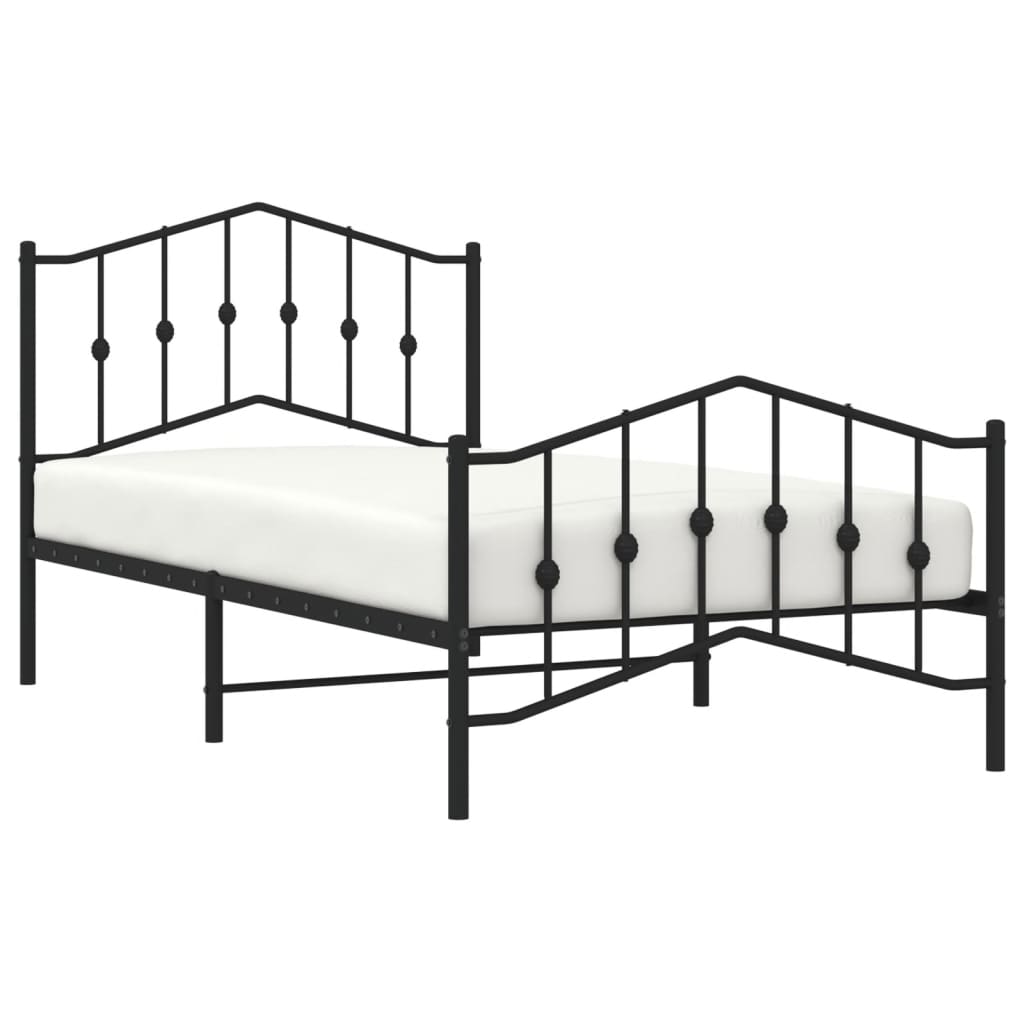 Black metal bed frame with decorative finials and a white mattress