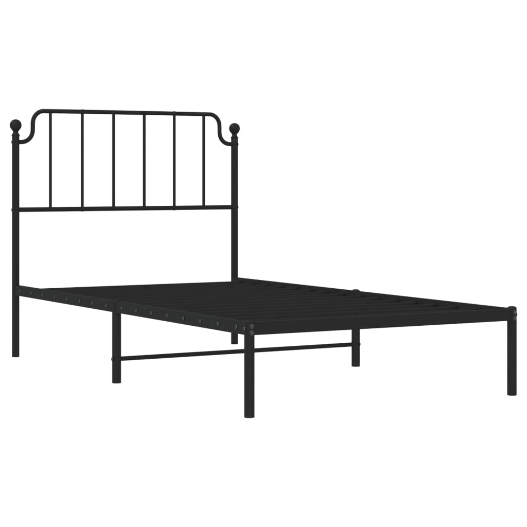 Black metal twin bed frame with decorative finials on headboard
