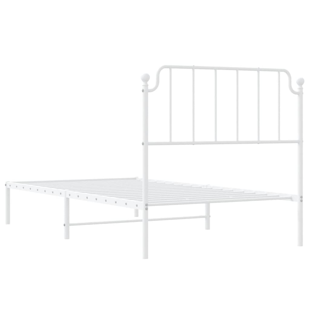 White metal twin bed frame with ornate headboard and slatted base