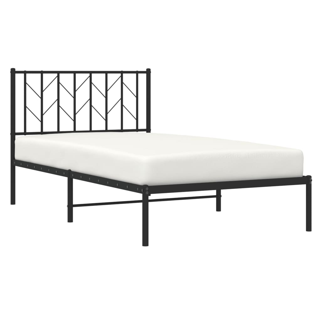 Black metal twin bed frame with geometric headboard and grey bedding