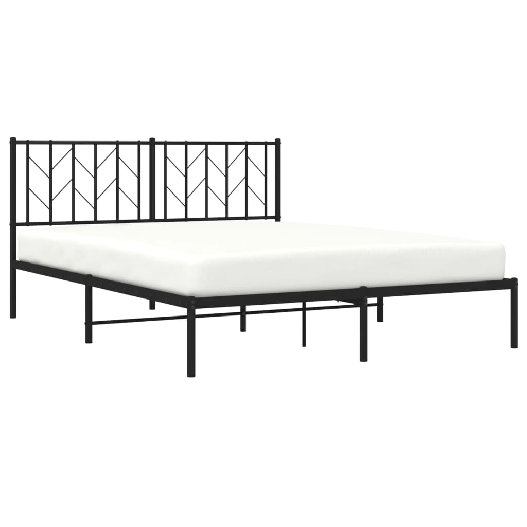 Black metal bed frame with geometric headboard and grey bedding