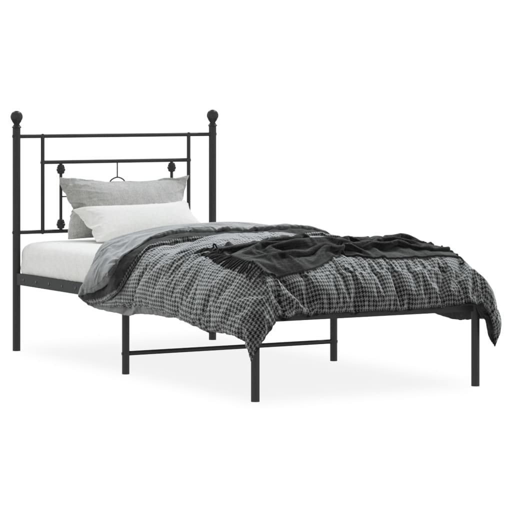 Black metal twin bed frame with decorative headboard and white mattress