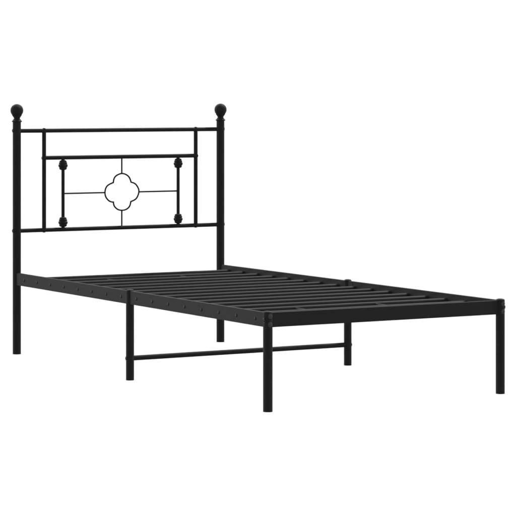 Black metal bed frame with decorative finials and patterned bedding