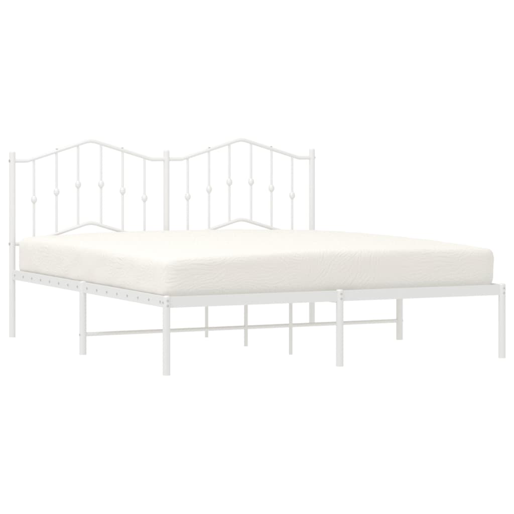 White metal bed frame with ornate headboard and mattress