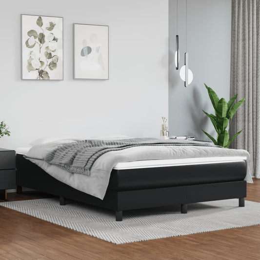 Modern black faux leather bed frame with a plush mattress and grey throw blanket