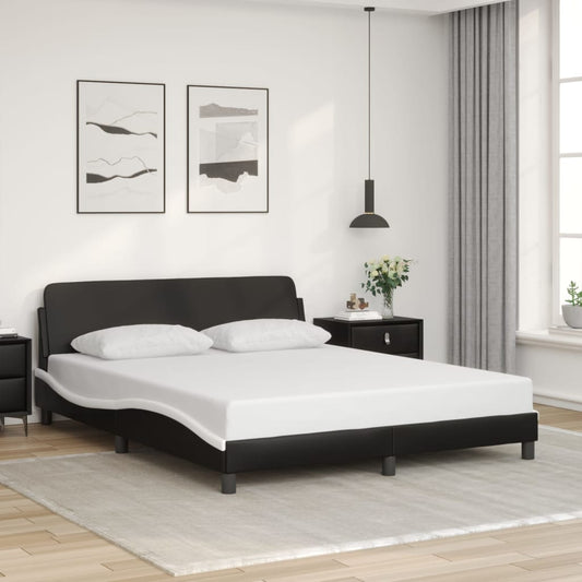 Black faux leather platform bed frame with a curved headboard and two white pillows