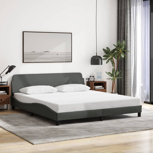 Modern grey fabric bed frame with curved headboard and two white pillows