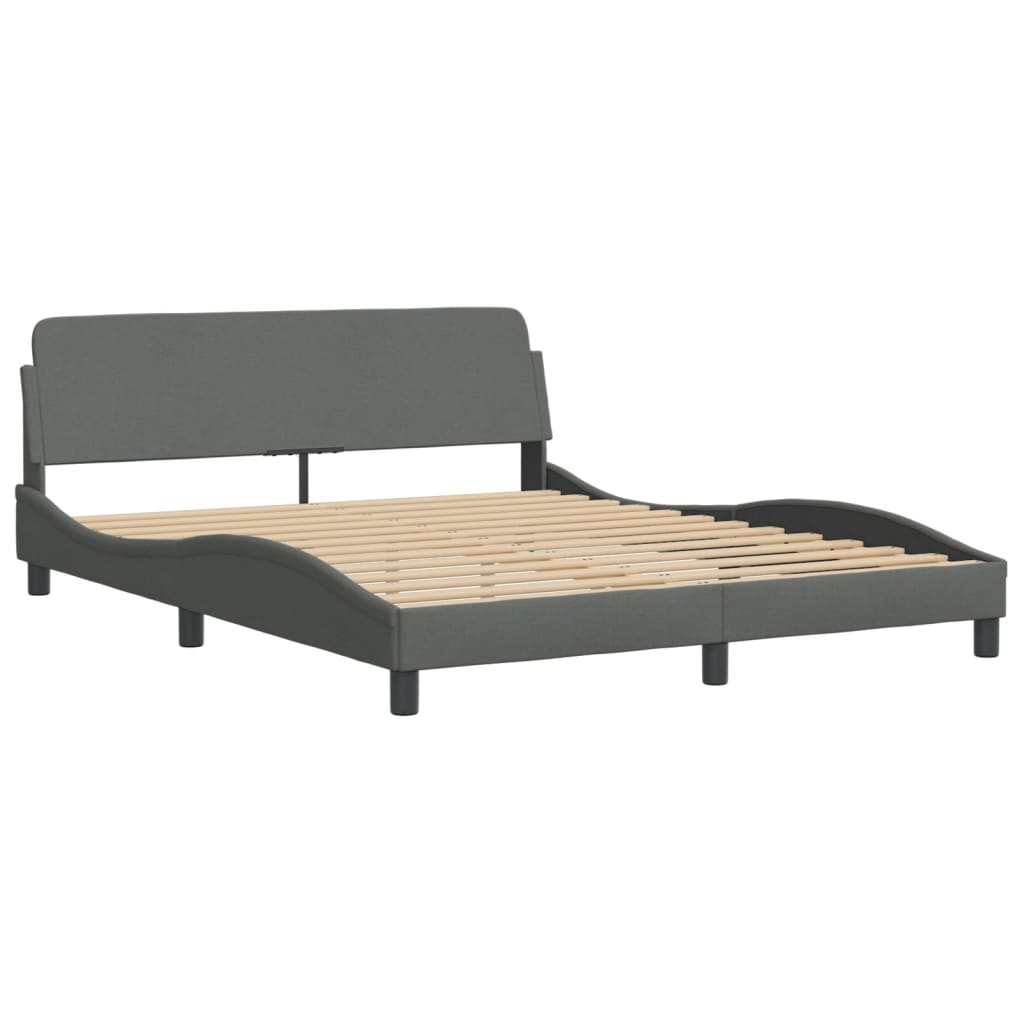 Modern grey upholstered bed frame with a curved headboard and white mattress