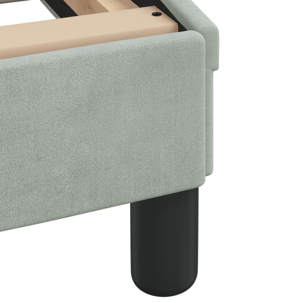 Light grey upholstered bed frame with wooden slats and a curved headboard