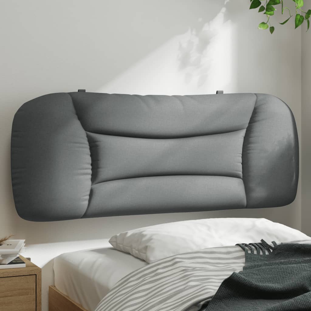 Tufted gray upholstered headboard mounted above a bed
