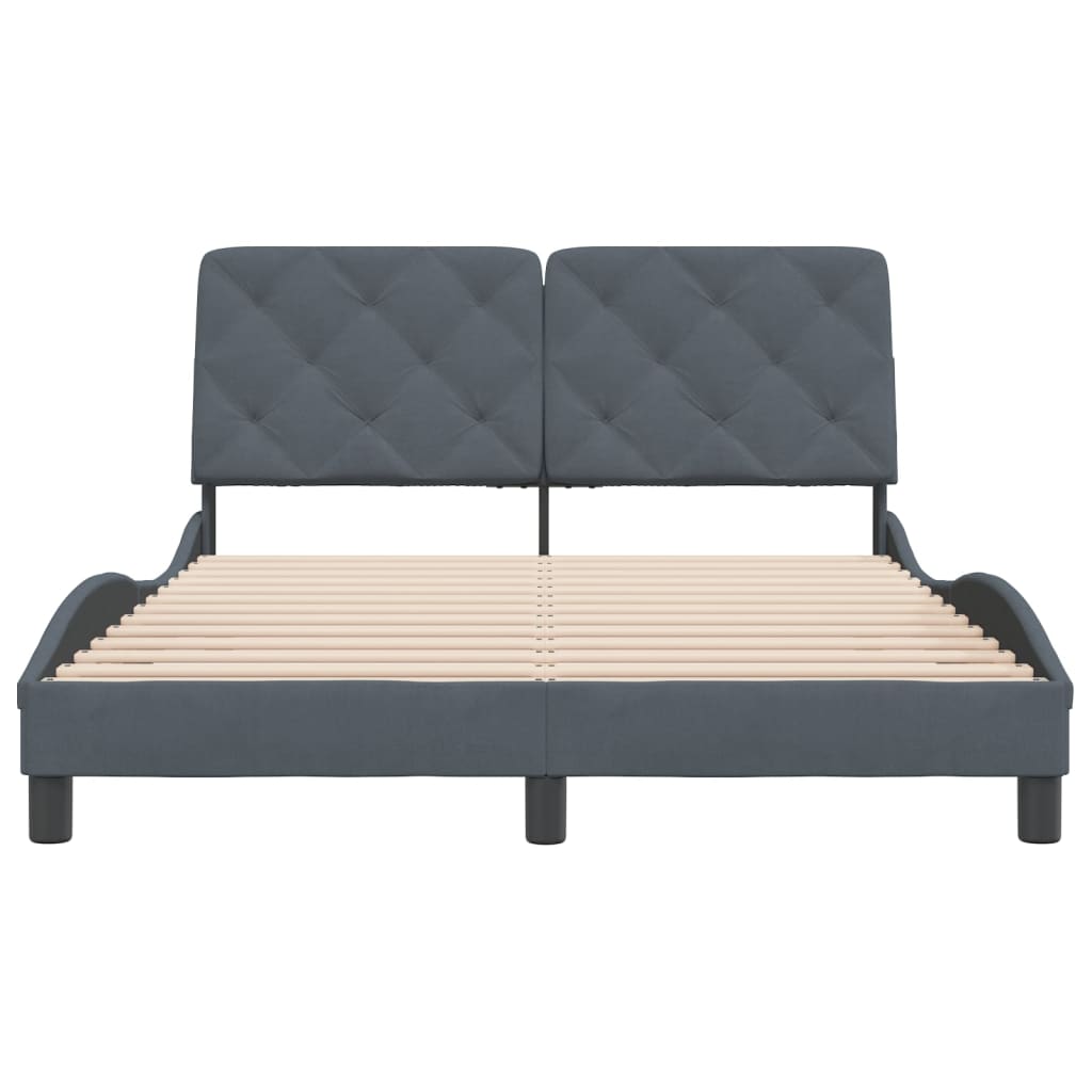 Dark grey upholstered bed frame with a tufted headboard and wooden slats