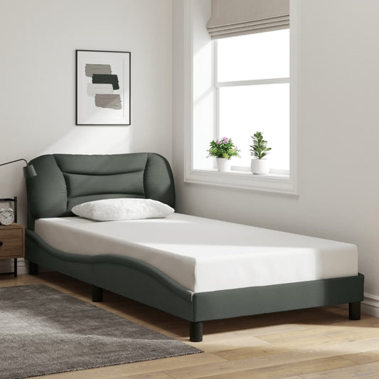 Modern upholstered twin bed in dark gray with curved frame and plush headboard