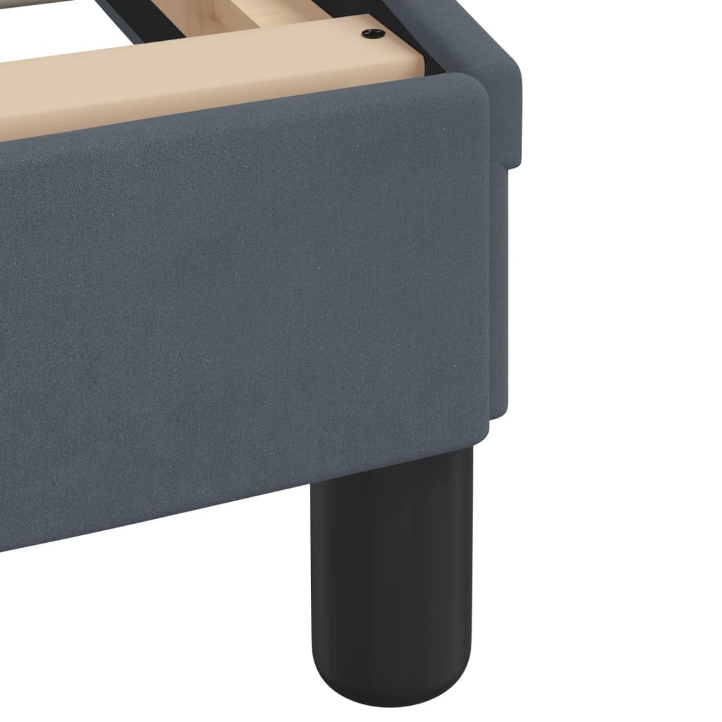 Dark grey upholstered bed frame with wooden slats and a curved headboard