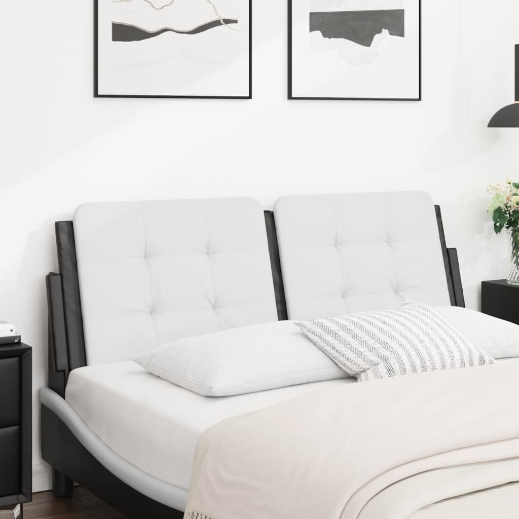 Tufted white leather sofa bed with dark frame and throw pillows