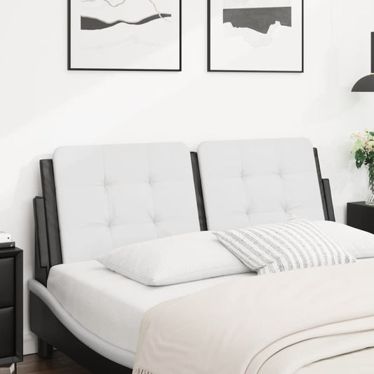 Tufted white leather sofa bed with dark frame and throw pillows
