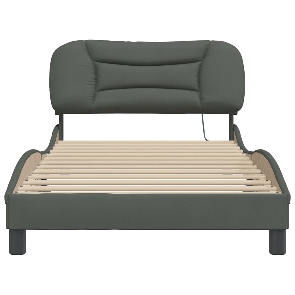 Dark gray fabric single bed frame with a curved headboard and mattress