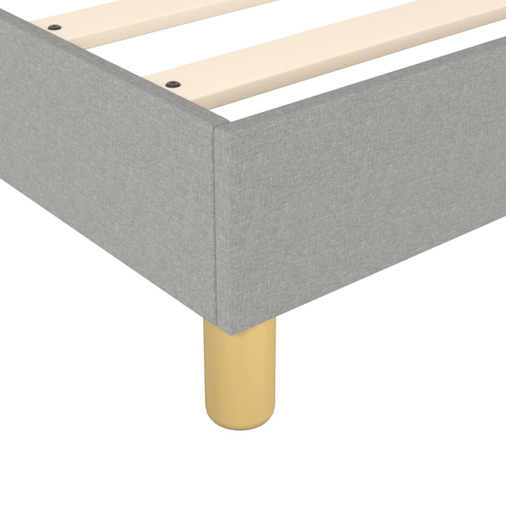 Gray fabric upholstered queen bed frame with wooden slats and tapered legs