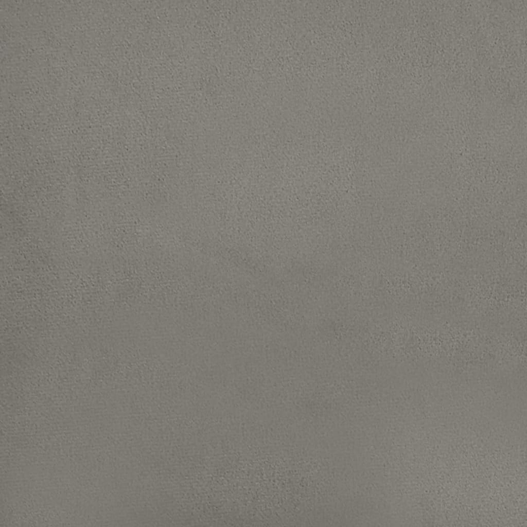 Closeup of a grey upholstered bed frame corner with black legs