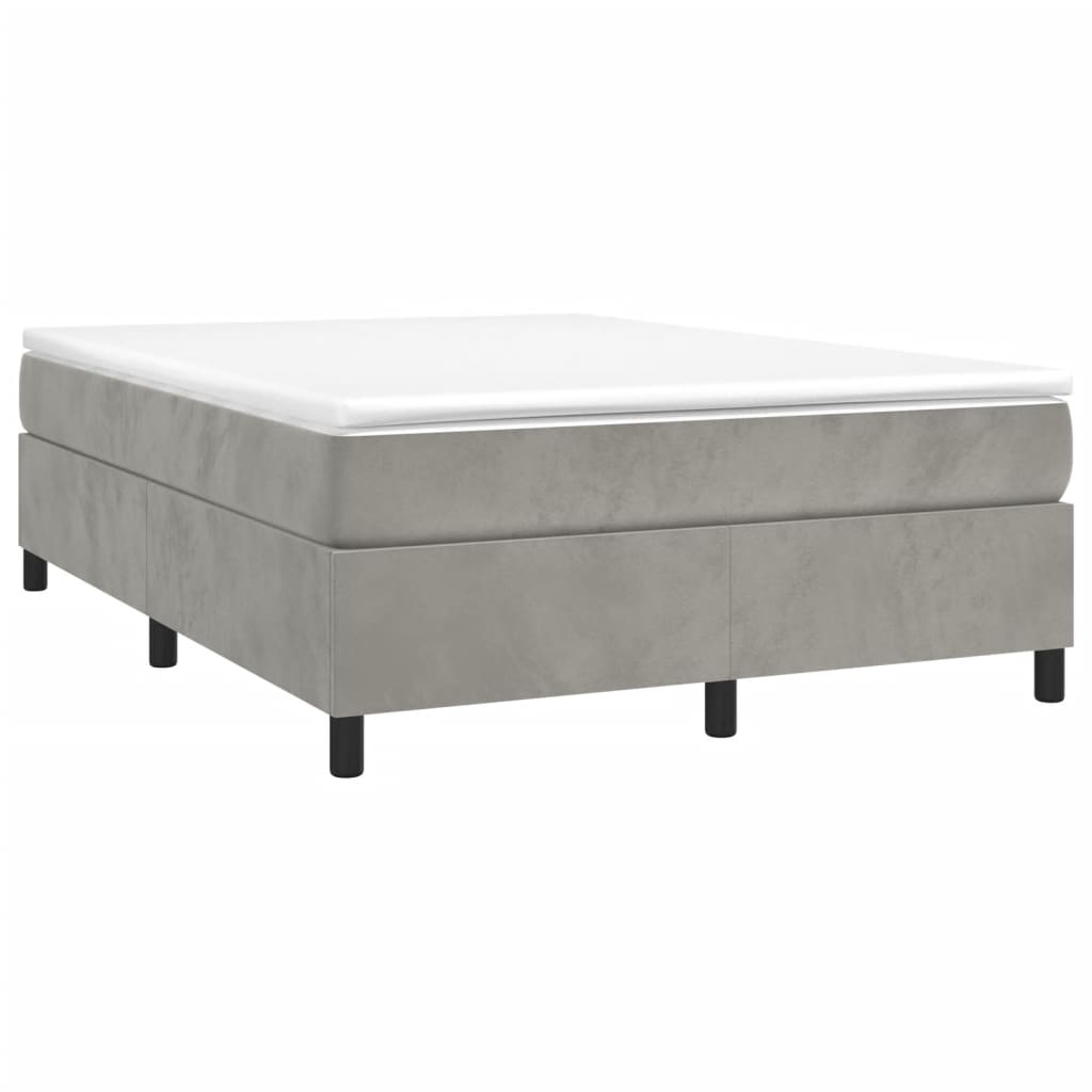 Upholstered grey bed frame with white mattress on black legs