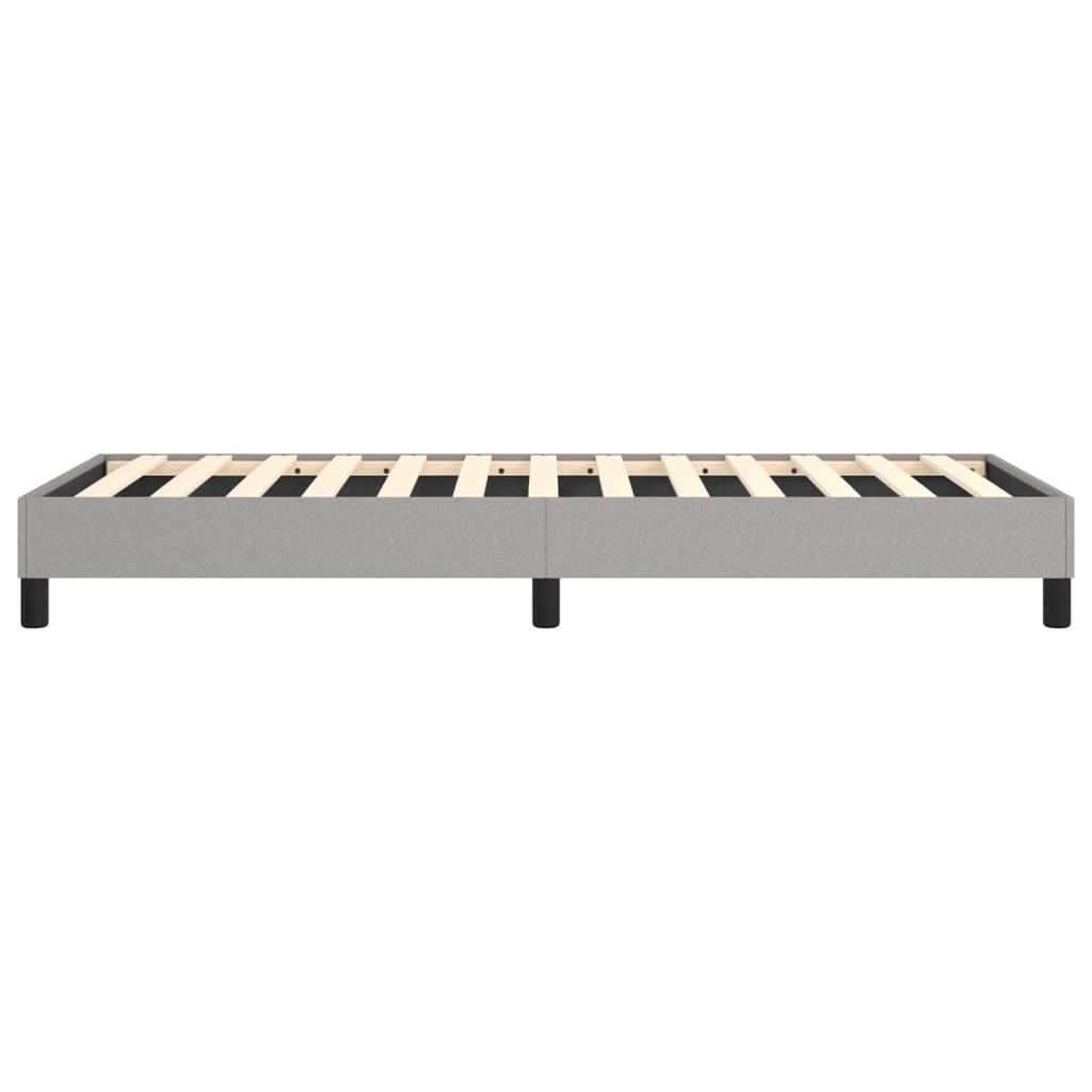 Grey upholstered bed frame with slatted wooden base and black legs