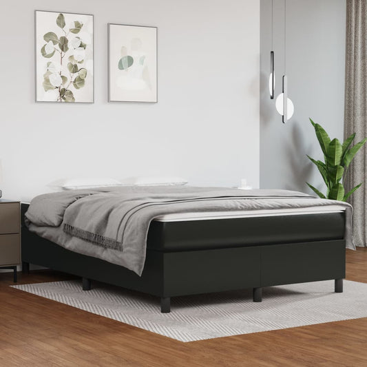 Black upholstered platform bed with a grey throw and white bedding