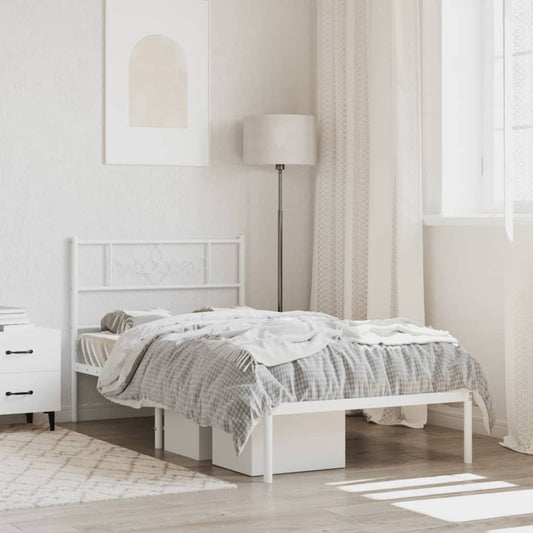 White metal twin bed frame with ornate headboard and attached shelf