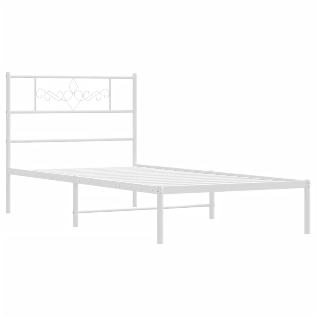White metal bed frame with ornate headboard and mattress