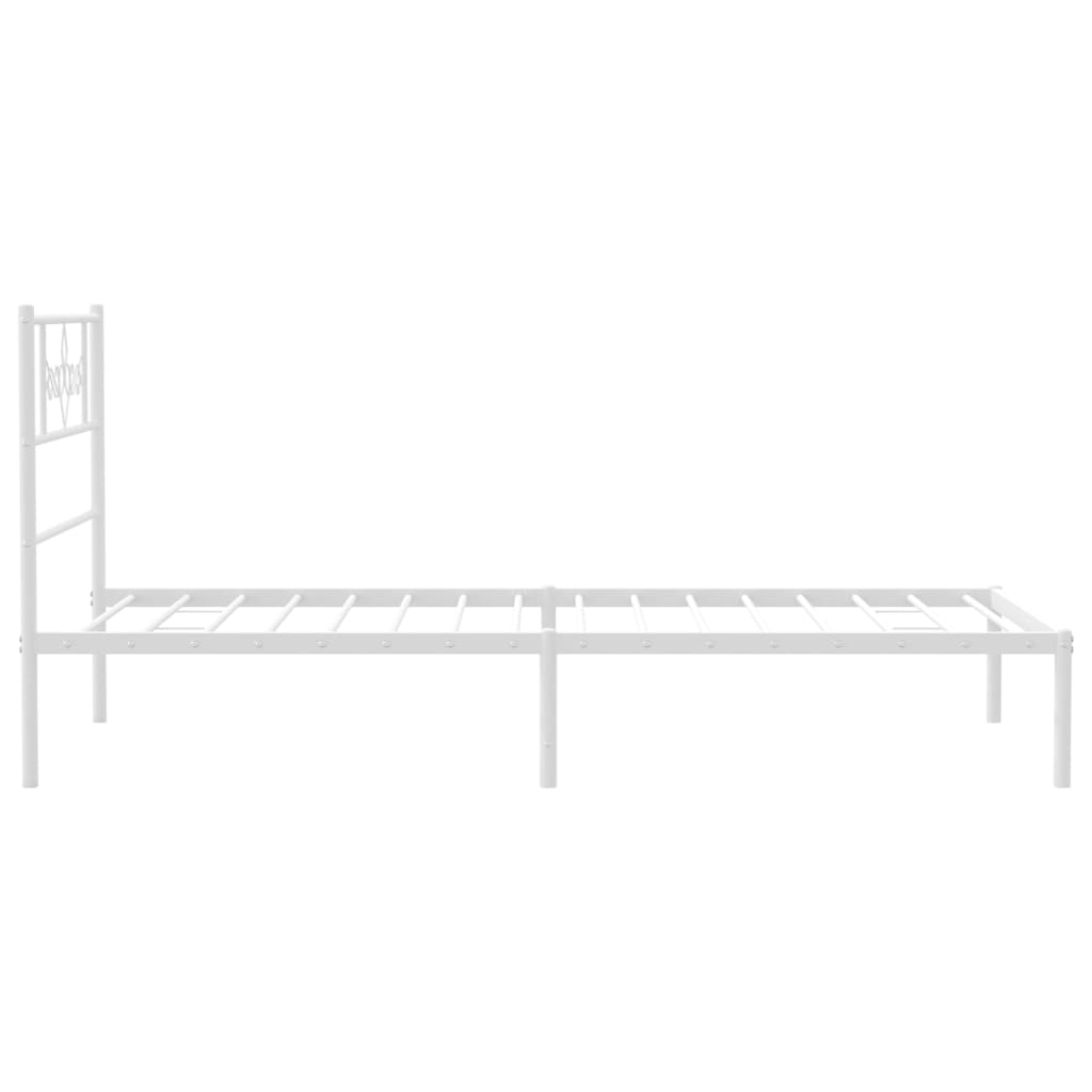 White metal bed frame with decorative headboard and mattress